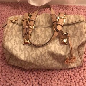 White, tan, and gold Michael Kors purse.